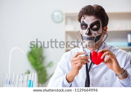 Scary monster doctor working in lab Royalty-Free Stock Photo #1129664996
