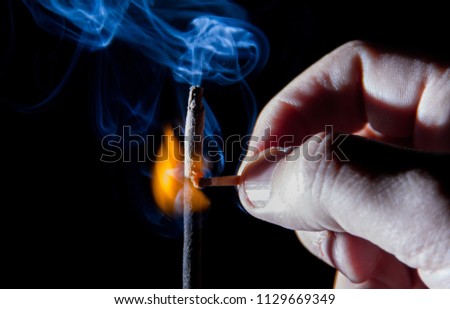 hand with flammable match stick