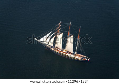 Aerial picture,  large sailboat goes to sea under sail. View from above.