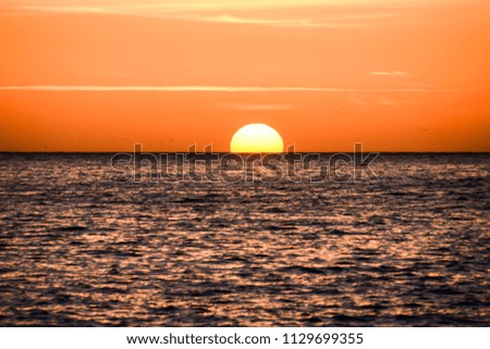 Photo Picture of The  Sun Setting in the Sea