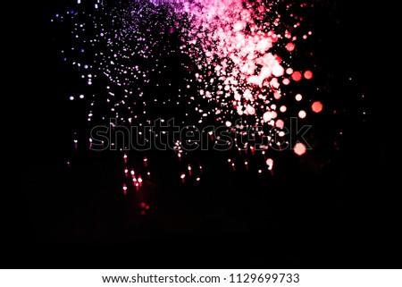 Freeze motion of color powder exploding/throwing color powder.