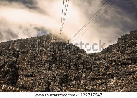 Stunning mountain landscape. Tourists climb up to the top of a mountain with a help of a cable way. Nature. Up in the clouds. Awesome view of a mountain top. 