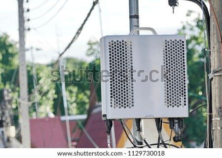 Small cellular 3G, 4G, 5G. Micro Base Station or Base Transceiver Station on Electricity post. Development of communication system in urban area.