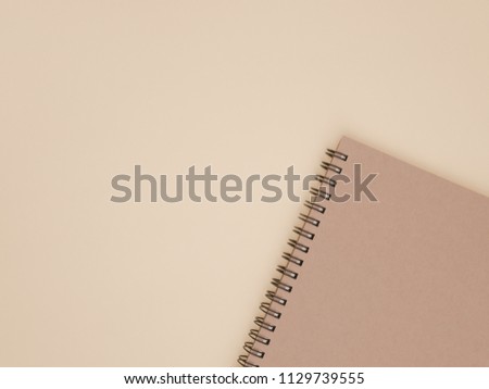 Top view of note book with on yellow for background. Flat lay