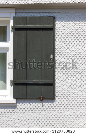 white wooden farmhouse facade and details in allgau south germany bavarian style on a sunshine summer day