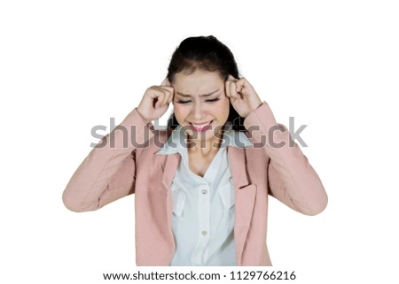 Picture of a Caucasian businesswoman looks stressful standing in the studio, isolated on white background