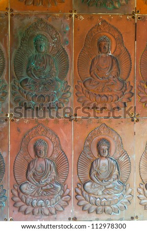 Old tile with the image of Buddha