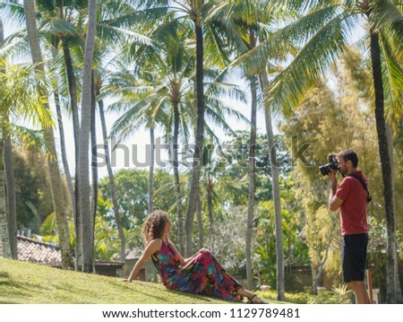 Professional photographer take photos of young pretty woman outdoors- private photo session concept outdoors