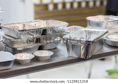 A lot of food aluminum containers. Metal forms for storing food. Forms for baking. Royalty-Free Stock Photo #1129811318