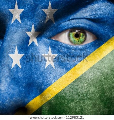 Flag painted on face with green eye to show Solomon Islands support
