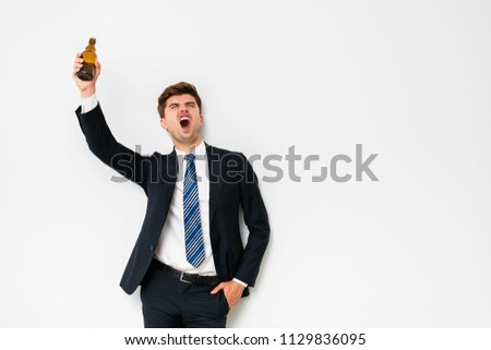 elegant man in suit having a beer after work, or celebrating some success, on white background