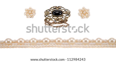 Pearl chain earrings and brooch pin breast-pin jewelry isolated on white background.