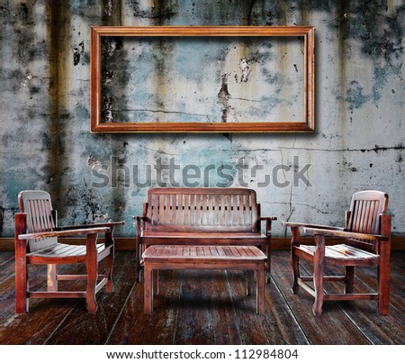 Picture frame and furniture in grunge room.