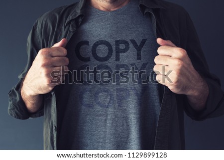 Copycat and plagiarism concept, repeating word Copy is fading on guy's t-shirt Royalty-Free Stock Photo #1129899128