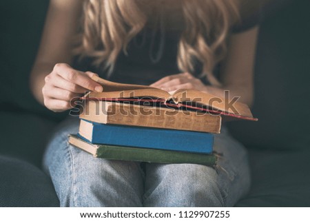 Young woman reading a book on a sofa