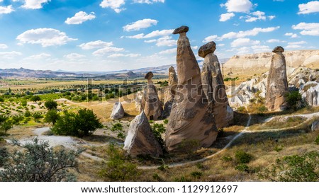 Fairy chimneys view near Cavusin Town in Cappadocia Royalty-Free Stock Photo #1129912697