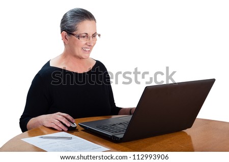 Photo of senior woman using a laptop computer isolated on white background