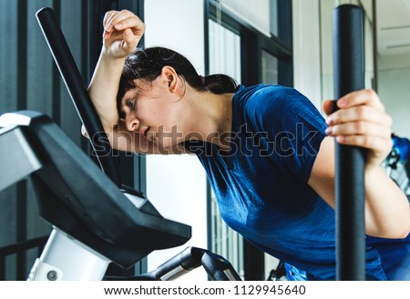 Woman tired after a hard workout Royalty-Free Stock Photo #1129945640