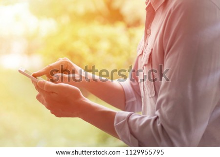 a casual man using smartphone with blurry background