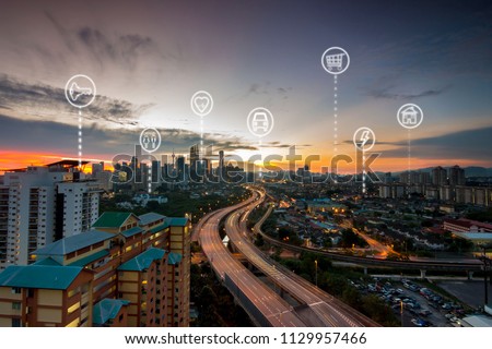 Sunset view of Kuala Lumpur city with smart city infographic elements and icons, networks and augmented reality concept.
