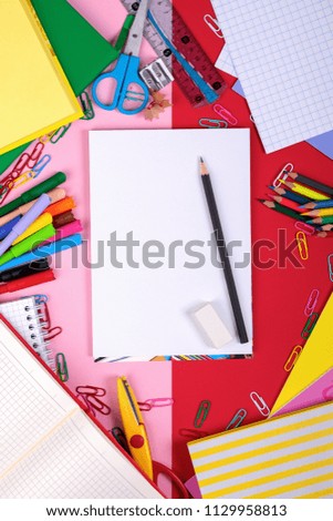 School supplies on blackboard background with copy space. Top view