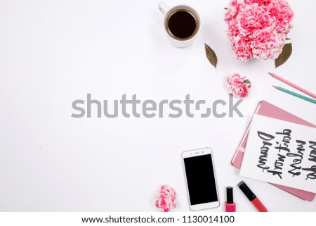Woman workspace with handwritten quote notebook, pink carnation flower, smartphone,  lipstick on white background. Flat lay, top view. stylish female blogger concept. spring summer background.