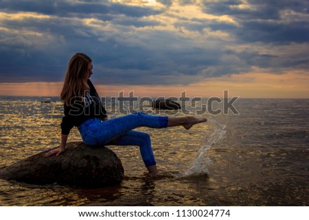 Young fairy girl at sunset at sea