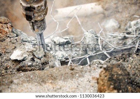 Close up of jackhammer - worker man using a jackhammer to drill into concrete 