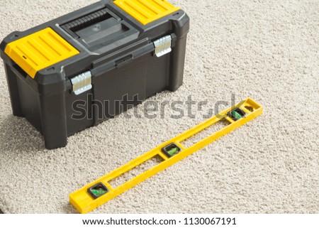 Closeup picture of toolbox and builders level