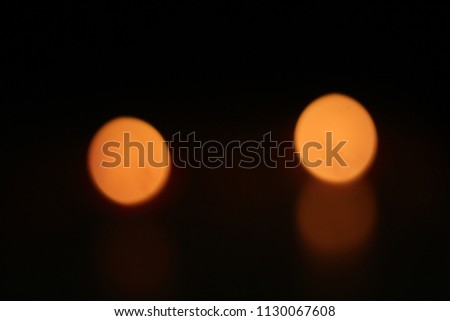 bokeh of a candle in a dark room