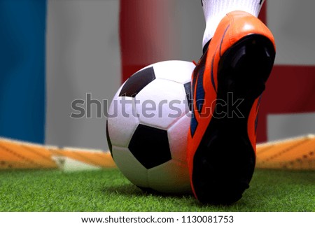 Close up legs and feet of soccer player or football player walk on green grass ready to play match on national France and national England.