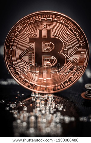 bitcoin laying on computer board, close-up
