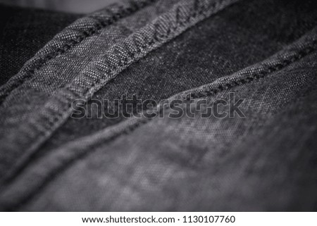 Grey denim Fabric with stitches, Macro photography. denim fabric wallpaper.