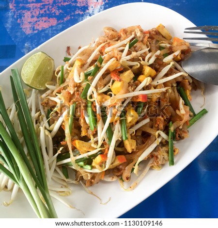 Thai style noodles. Noodles stired with peanut, tofu, egg and small dry shrimp. Padthai is famous thai cuisine. Street food Royalty-Free Stock Photo #1130109146