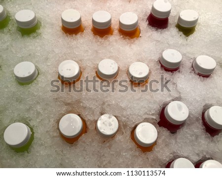 Bottles of juice is in the ice