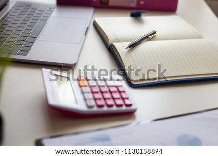 Pen with note and laptop , calculator on desk of financial planing. Financial abstract concepts.