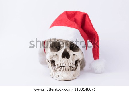 Skull with red Christmas hat on white background