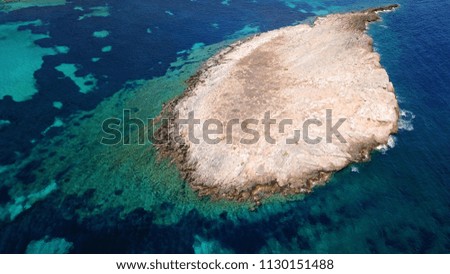Aerial bird's eye view photo taken by drone of tropical rocky seascape with turquoise clear waters and small caves