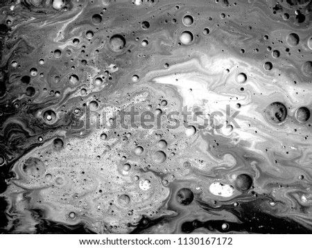 abstract art background.oil and water.Free movement of white and black.