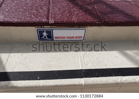 The inscription on the steps - "watch your step"