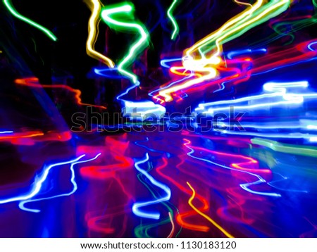 Abstract light paint art with colorful lights backdrop high speed motion in dark and shadow. Include Red Blue Green Gold Orange long lines pattern. This drawing shape loop photo is luxury neon design.