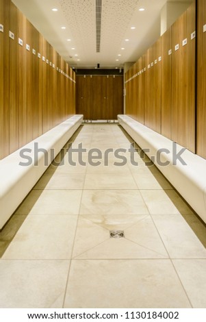 Modern Storage lockers in a swimming pool with bench , and led lighting