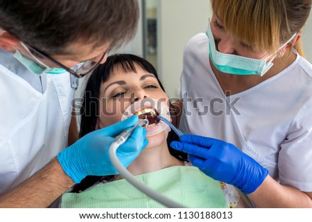Doctor and nurse are working with patient in dentistry
