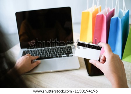 Woman and Small shopping cart with Laptop for Internet online shopping concept