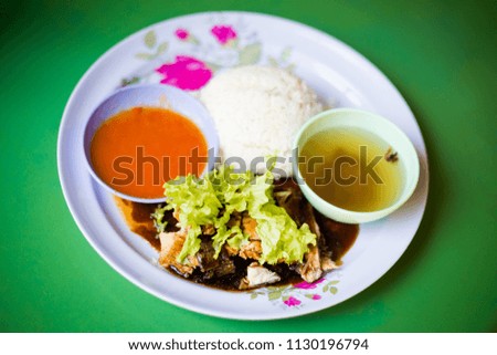 Fresh prepared malaysian chicken set served with rice and sweet chilli sauce and clear soup in local restaurant in Malacca. Traditional asian cuisine made of fresh ingredients.