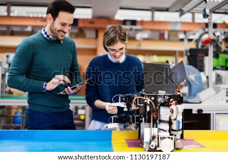 Young students of robotics working on project