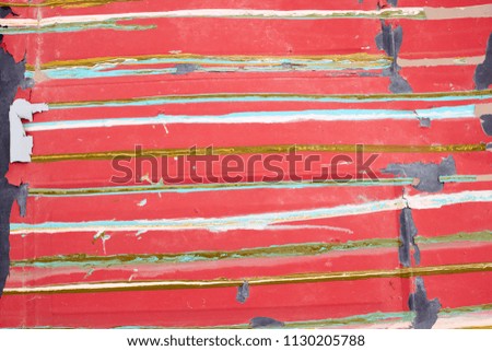 Background Close Up Detail of Old Red Weathered Surface with Multicolored Lines Striped Horizontally Across Image