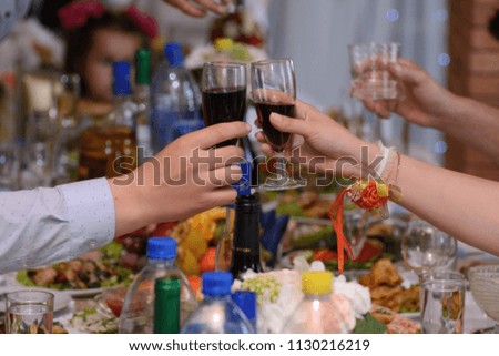 Hands with glasses of wine are stretched to each other