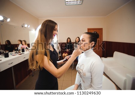 Make-up artist work on her friend. Real people.