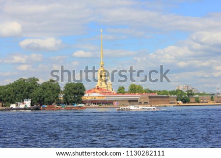 Peter and Paul Fortress in Saint Petersburg, Russia. Summer Scenic Skyline View across Neva River. St. Petersburg Cityscape with Cathedral Top on Hare Island, City Travel Landmark on Sunny Summer Day.